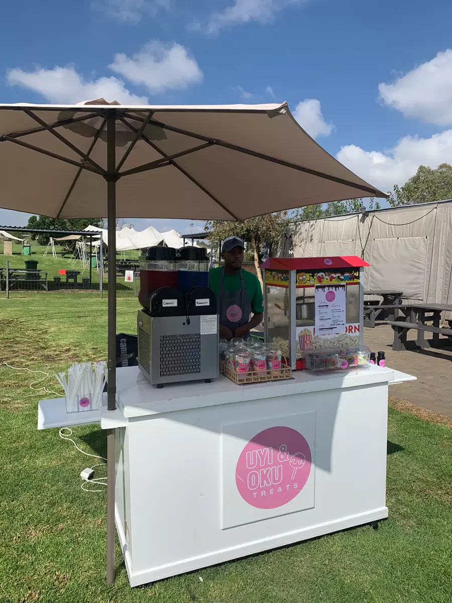 Uyi and Oku Treats stall at an outdoor market