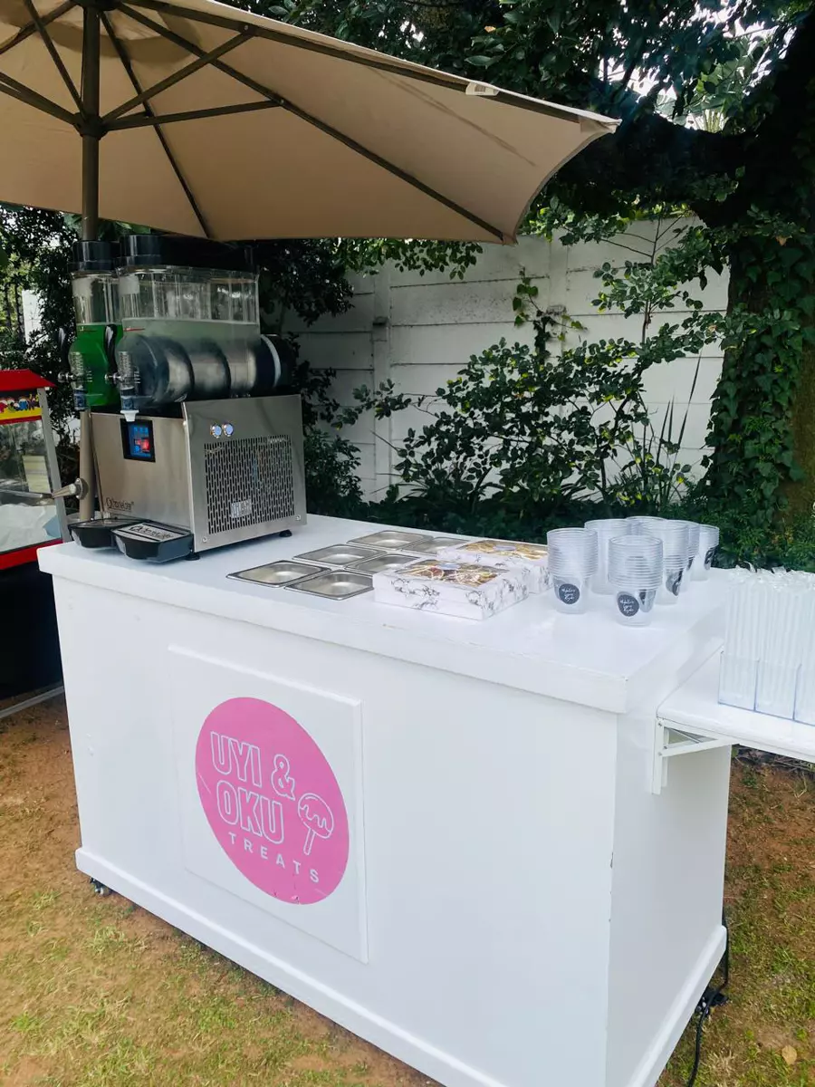 Uyi and Oku Treats white treat cart at an event